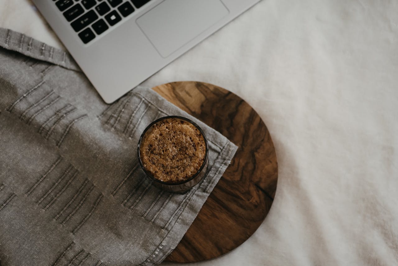 why-choose-us A warm, cozy home office setup with coffee and laptop on a wooden surface, ideal for remote work.