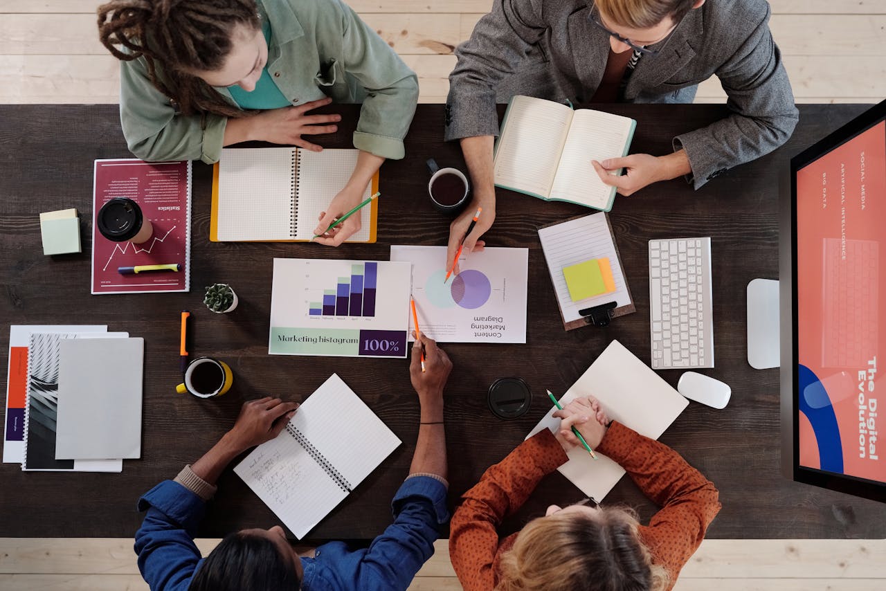 digital Overhead view of diverse professionals collaborating on a project in a modern office setting.